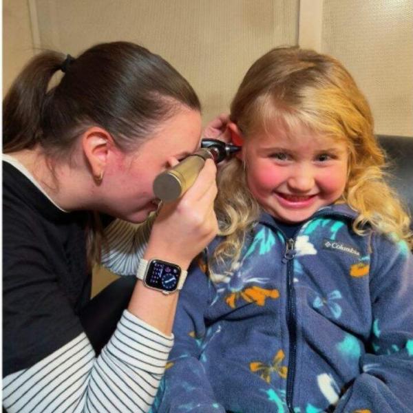 Dr. Wirfel performing an  otoscope exam on a pediatric patient.